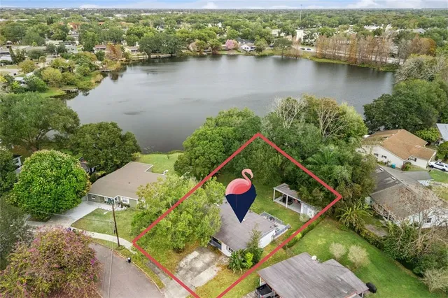 an aerial view of house lake and residential houses with outdoor space