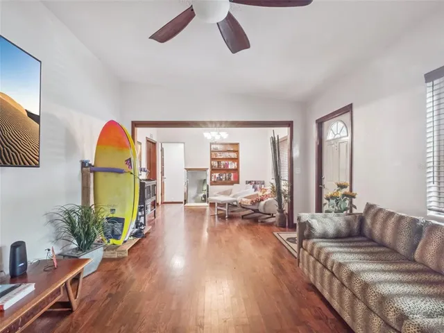a living room with furniture fireplace and wooden floor
