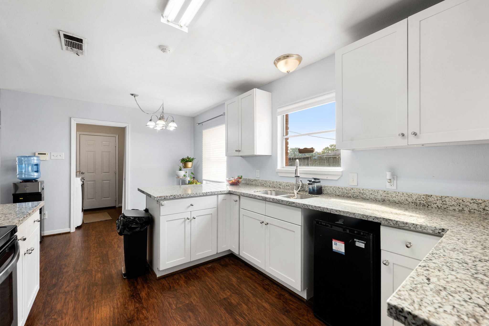 6019 Cartagena Street Houston, TX 77035 - Photo 13 of 29 a kitchen with a sink cabinets and wooden floor