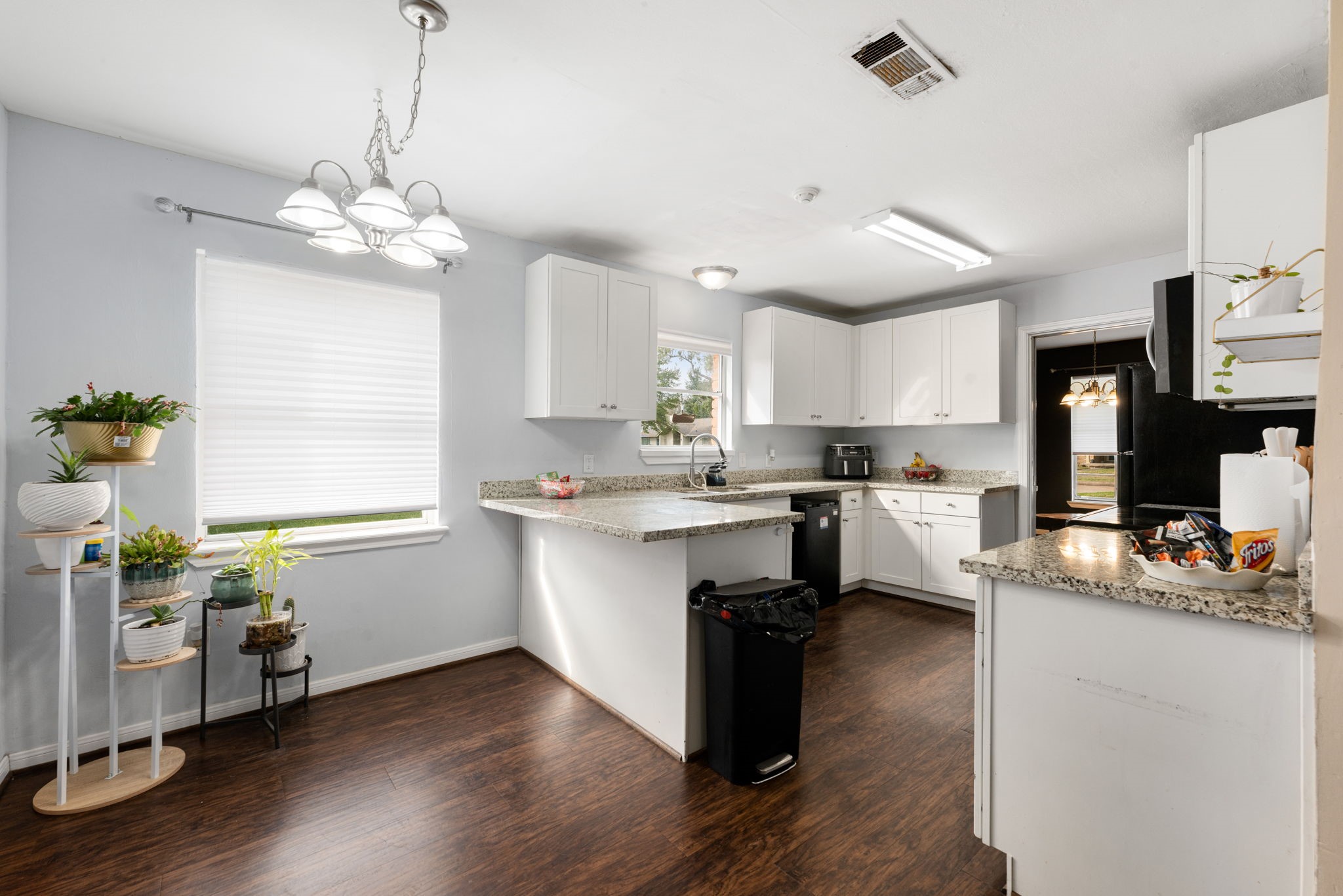6019 Cartagena Street Houston, TX 77035 - Photo 16 of 29 a kitchen with granite countertop a window a sink and cabinets