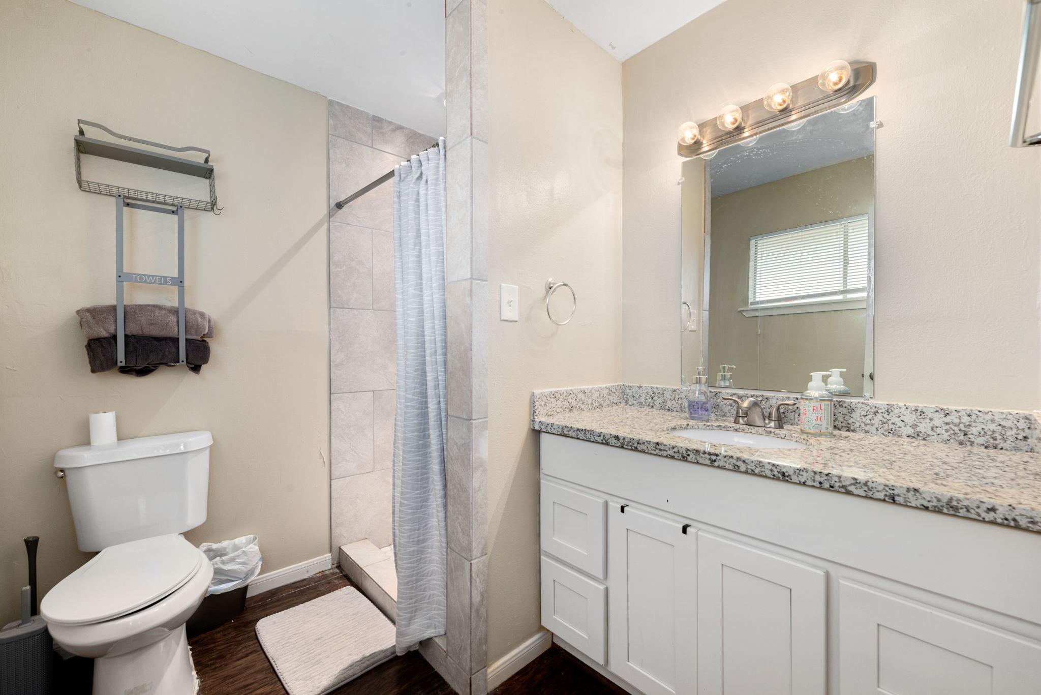 6019 Cartagena Street Houston, TX 77035 - Photo 21 of 29 a bathroom with a granite countertop sink toilet and mirror