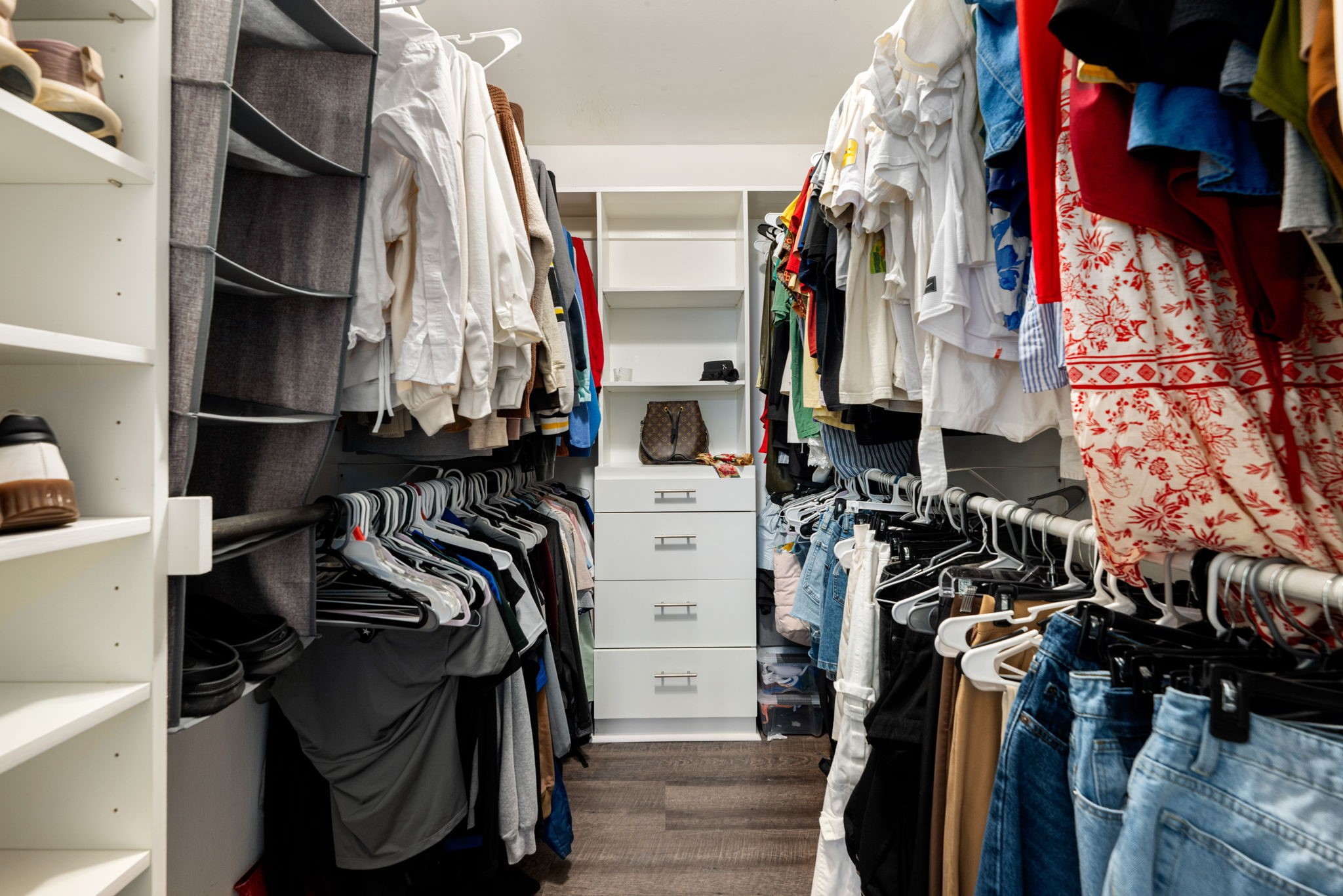 6019 Cartagena Street Houston, TX 77035 - Photo 22 of 29 a view of walk in closet with clothes and shoes