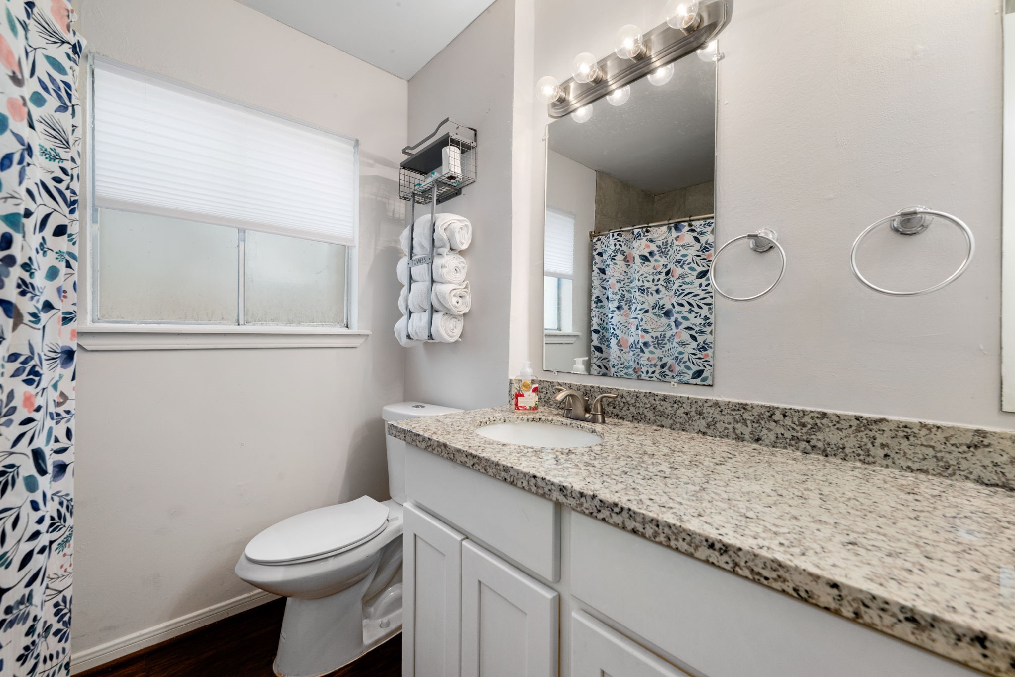 6019 Cartagena Street Houston, TX 77035 - Photo 25 of 29 a bathroom with a granite countertop sink a toilet and shower