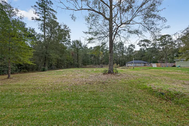a view of outdoor space with deck and yard