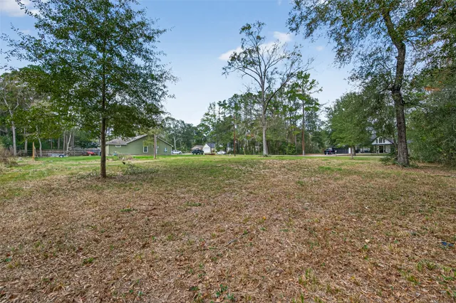 a view of a field with tree in the background