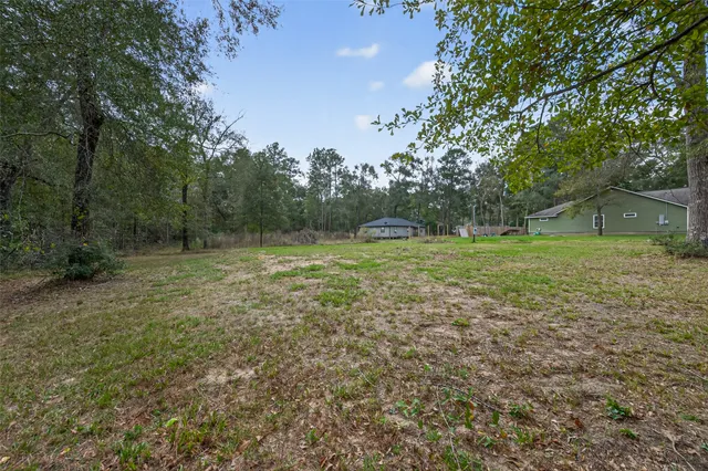a view of outdoor space with deck and yard