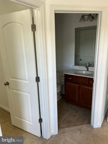 a bathroom with a sink a mirror and a vanity