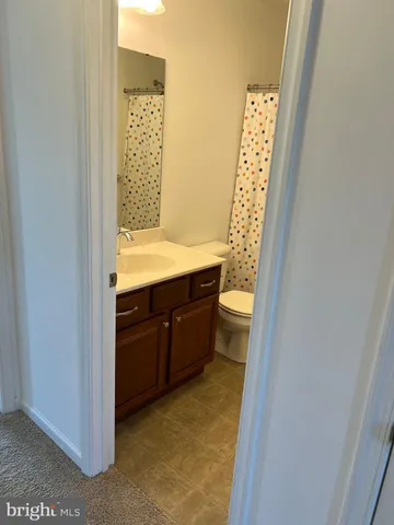 a bathroom with a granite countertop sink a vanity and a mirror