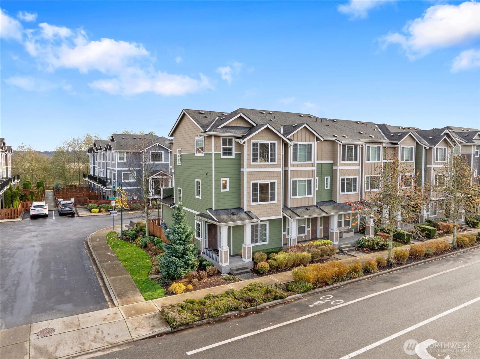 a front view of a house with a garden and balcony