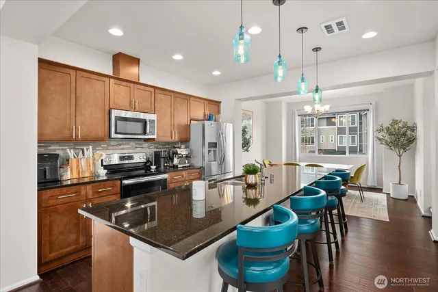 a kitchen with counter space appliances and a dining table