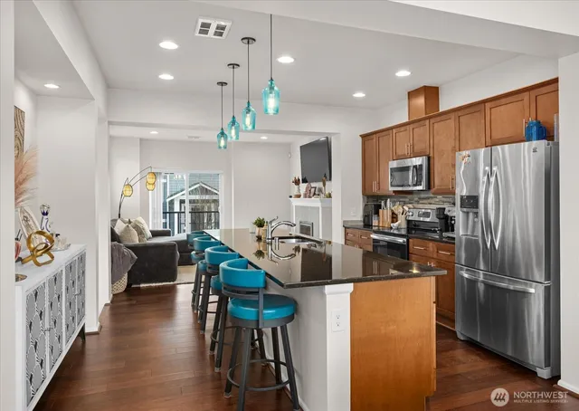 a kitchen with sink refrigerator and microwave