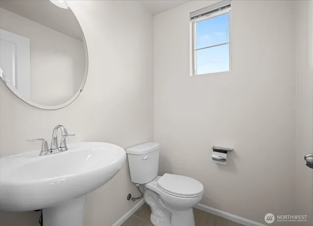 a bathroom with a sink mirror and toilet