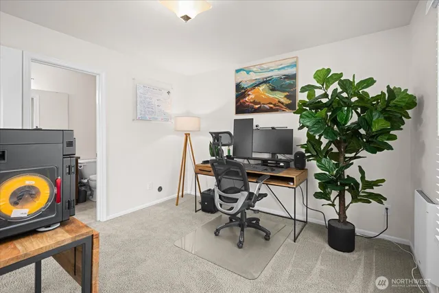 a view of a workspace with furniture and a potted plant