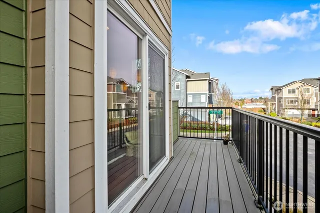 a view of a balcony with wooden floor and fence