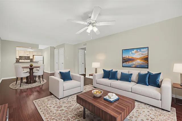a living room with furniture and wooden floor