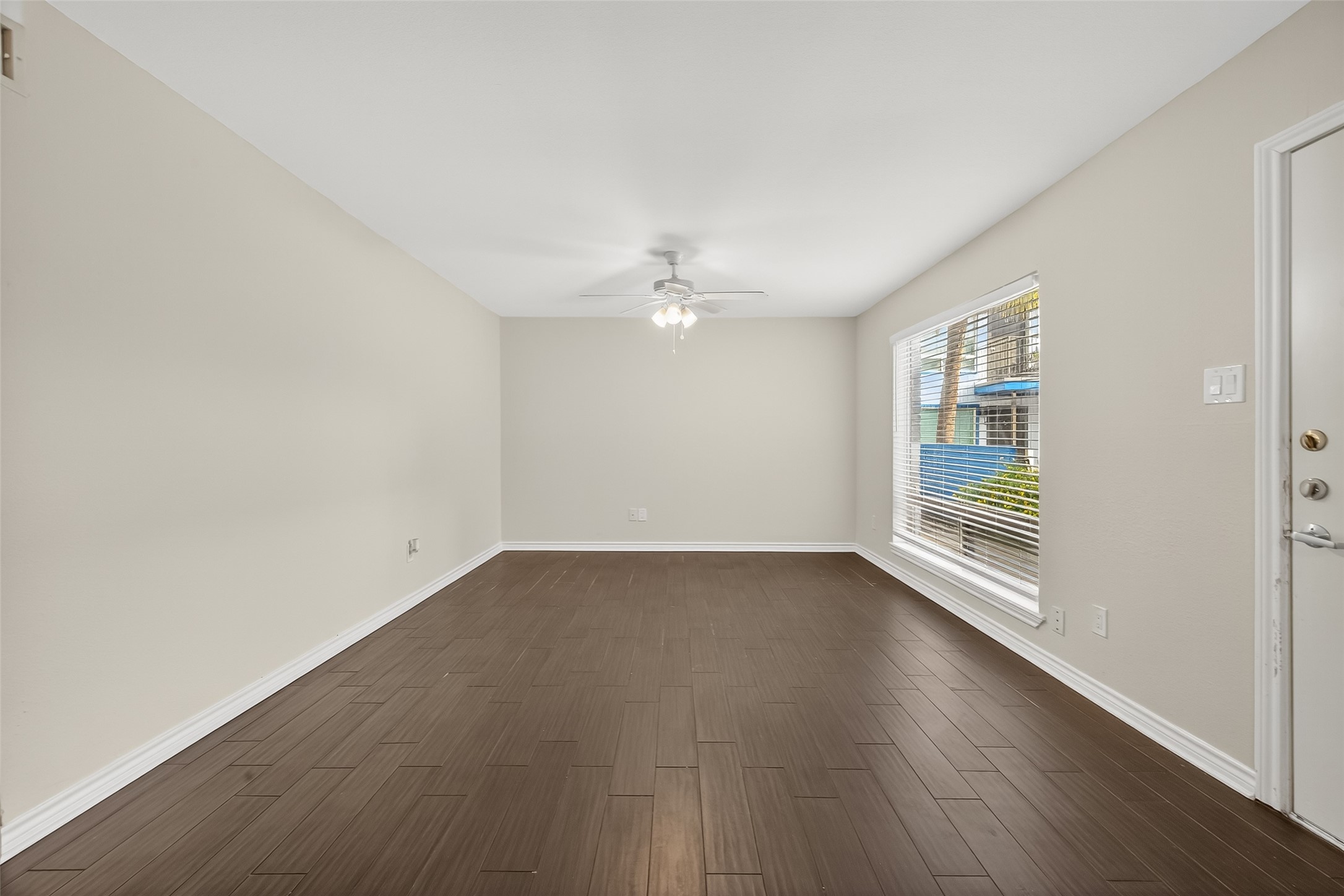 2020 Huldy Street, Unit 2 Houston, TX 77019 - Photo 12 of 34 an empty room with wooden floor and windows