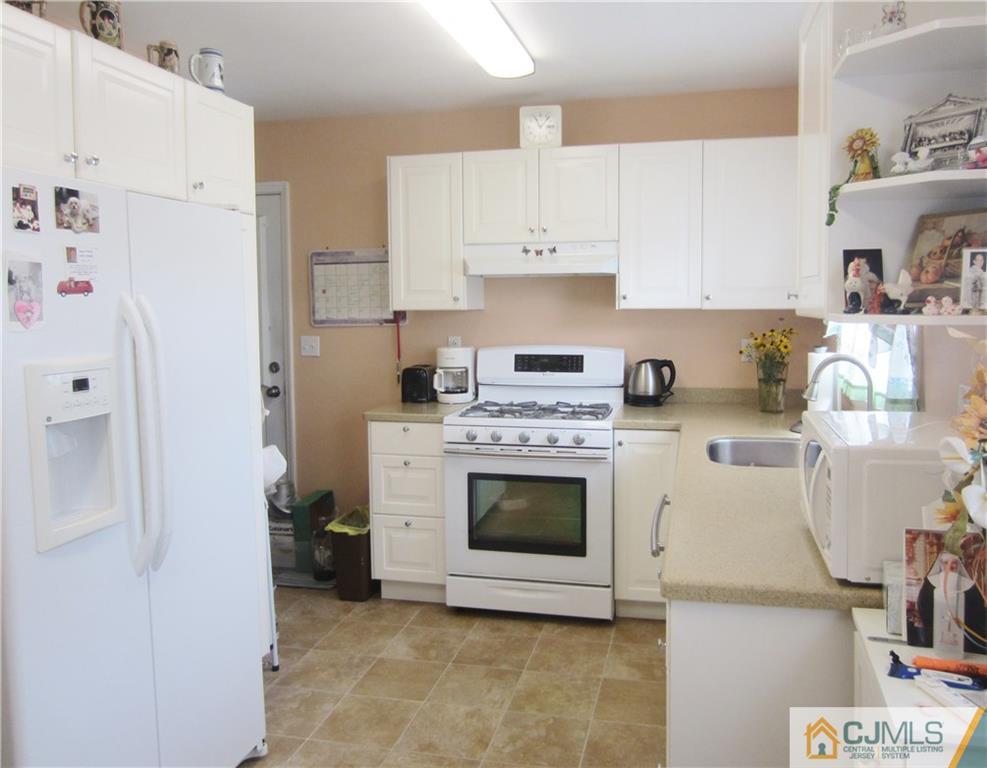 336 Old Post Road Edison, NJ 08817 - Photo 8 of 15 a kitchen with white cabinets and white appliances