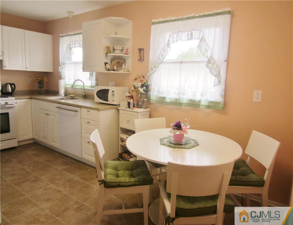 336 Old Post Road Edison, NJ 08817 - Photo 9 of 15 a kitchen with a dining table chairs and window