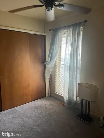 a view of empty room with windows and cabinet