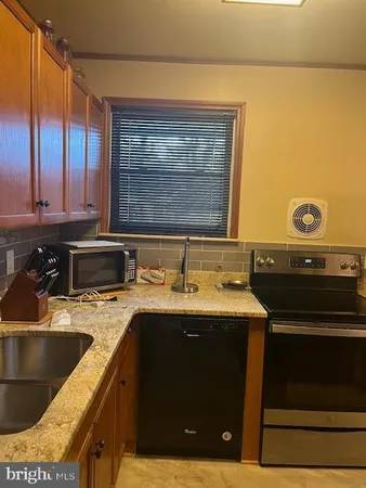 a kitchen with a sink and a stove