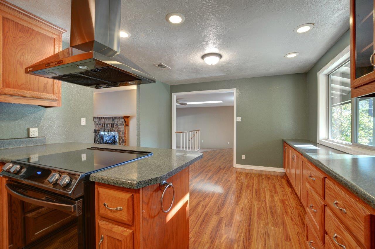 833 Upper Applegate Road Jacksonville, OR 97530 - Photo 17 of 58 a kitchen with granite countertop a stove and a sink