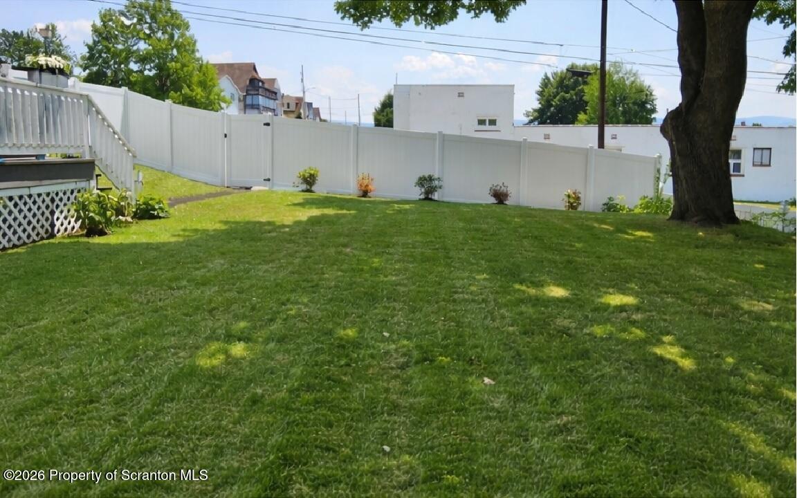 1803 Academy Street Scranton, PA 18504 - Photo 17 of 47 a backyard of a house with plants and large tree