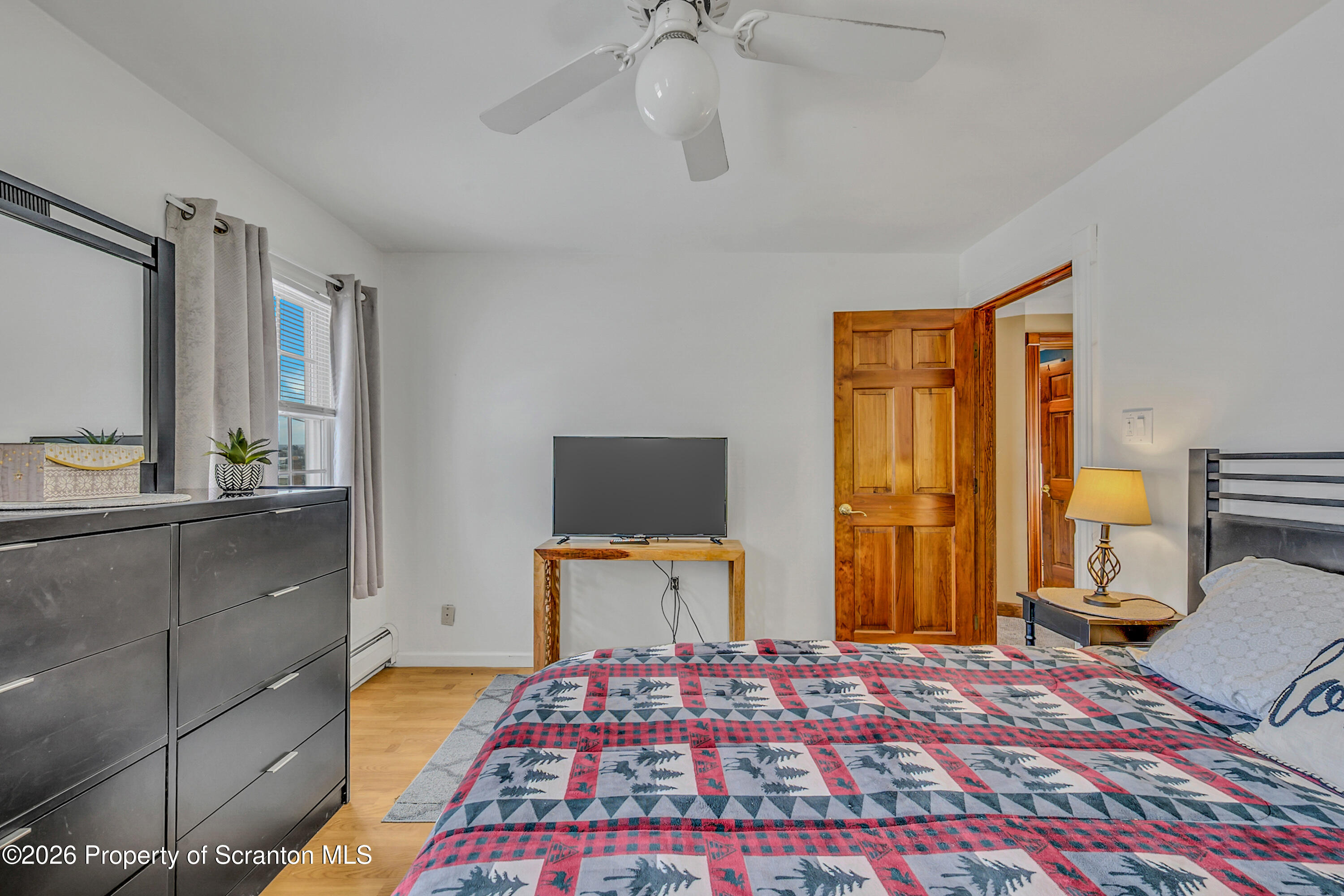 1803 Academy Street Scranton, PA 18504 - Photo 23 of 47 a bedroom with a bed and wooden floor