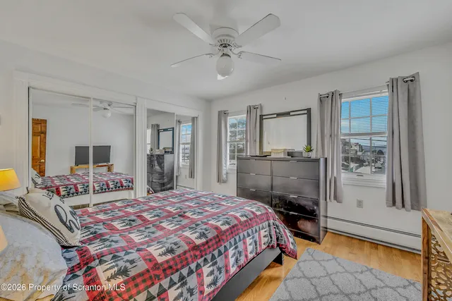 a view of kitchen with stainless steel appliances wooden cabinets and stove top oven