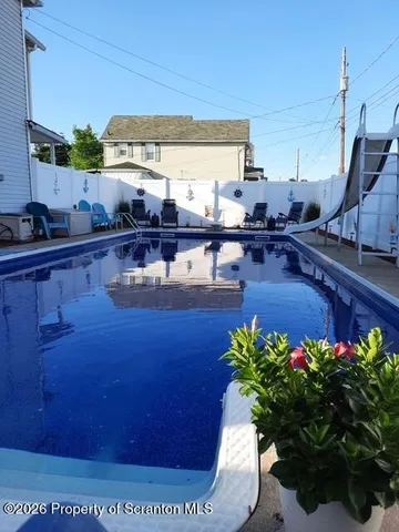 a bathroom with a granite countertop toilet a sink and a mirror
