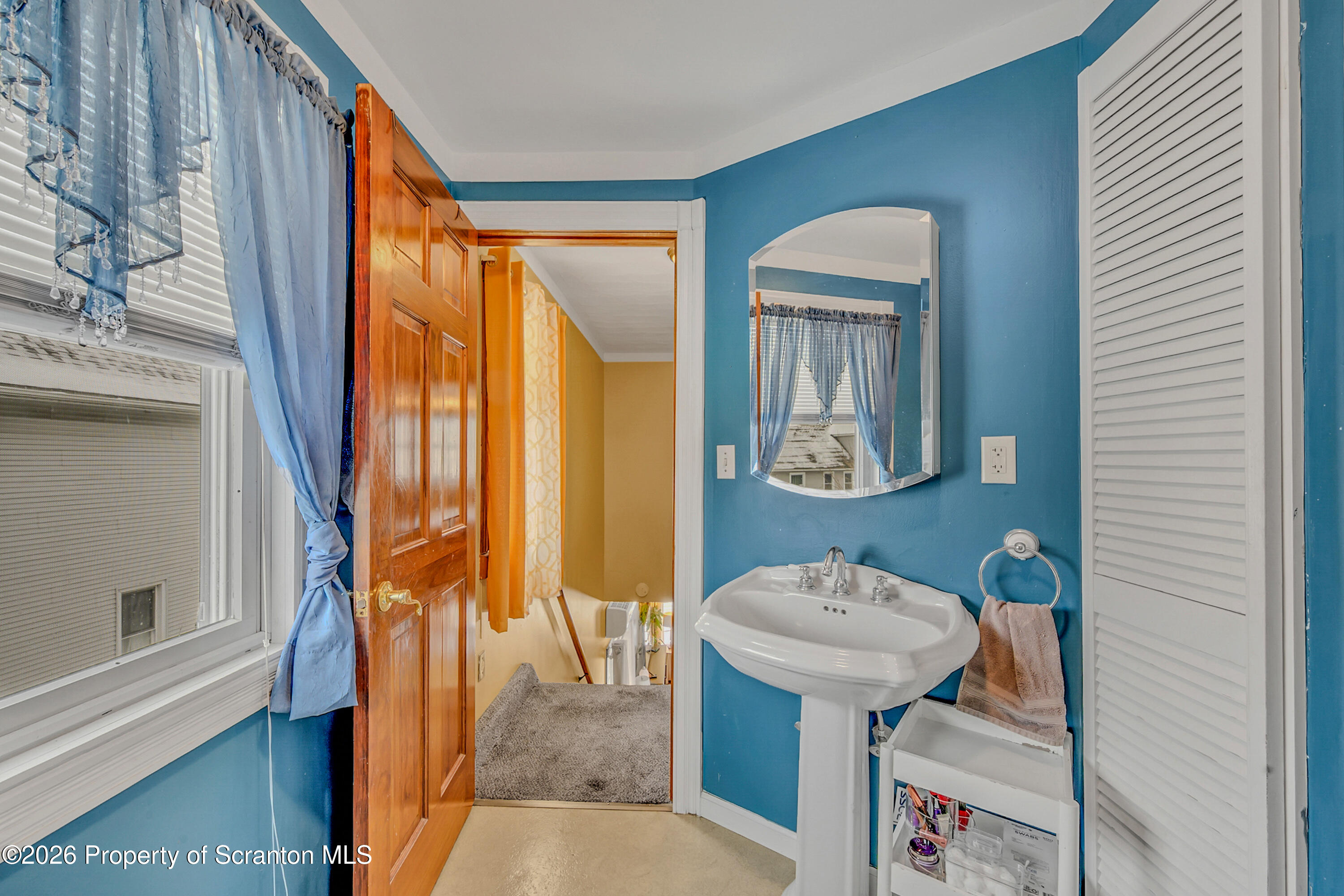 1803 Academy Street Scranton, PA 18504 - Photo 30 of 47 a bathroom with a sink toilet and mirror