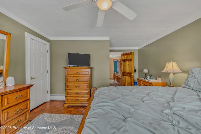 a view of a room with bathtub and wooden floor