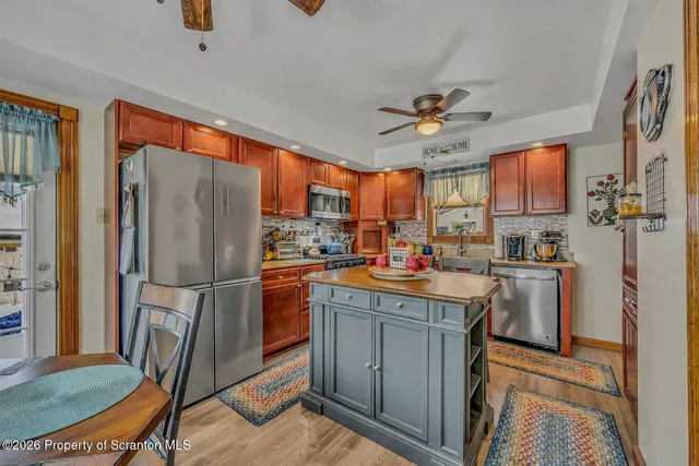 a kitchen with refrigerator cabinets and a sink