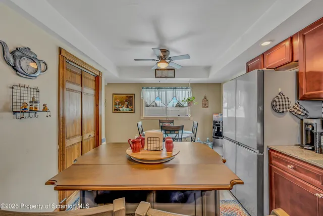 a view of a dining room with furniture a chandelier and wooden floor