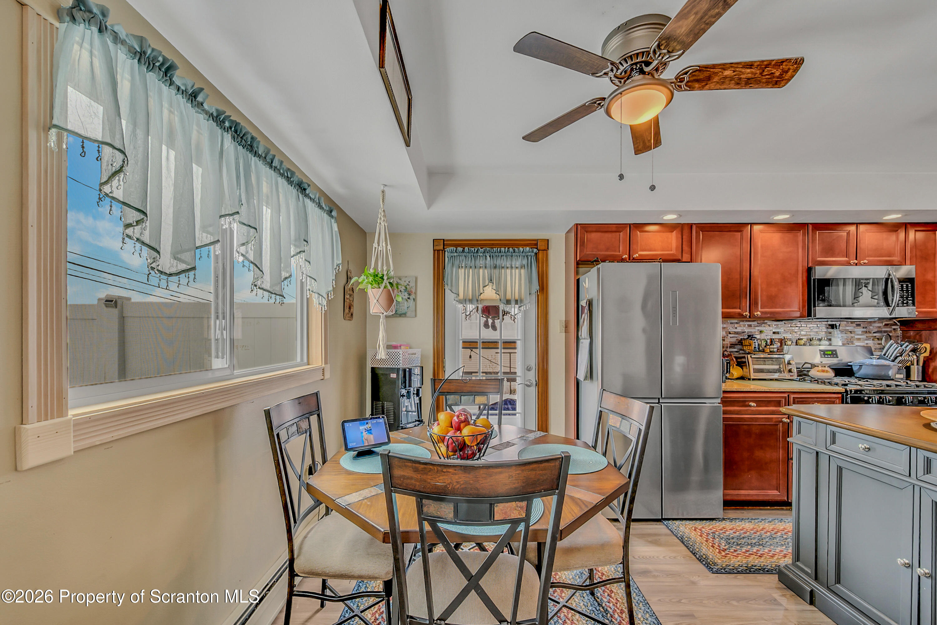 1803 Academy Street Scranton, PA 18504 - Photo 10 of 47 a dining room with stainless steel appliances kitchen island granite countertop furniture and a refrigerator