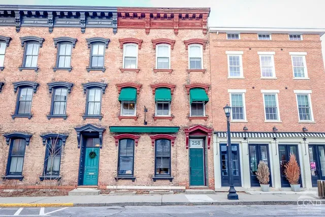 a balcony with wooden floor and breakfast area