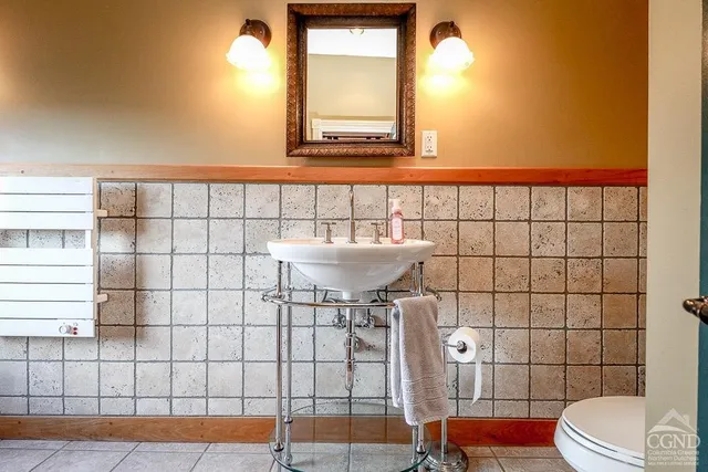 a bathroom with a tub a mirror and a shower