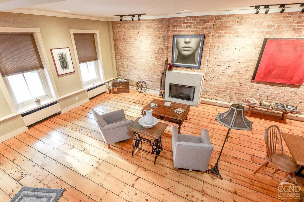 258 Warren Street Hudson, NY 12534 - Photo 14 of 31 a living room with patio furniture and a fireplace