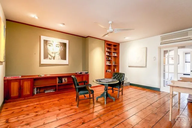 a view of a bedroom with wooden floor and a window