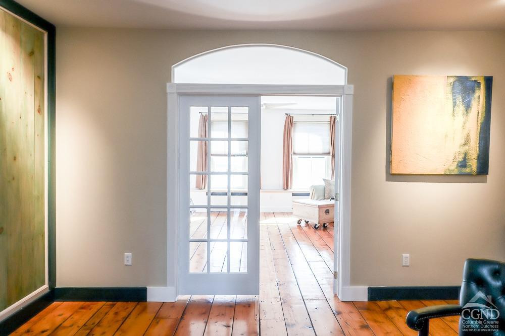 258 Warren Street Hudson, NY 12534 - Photo 16 of 31 a view of a bedroom with wooden floor and a window