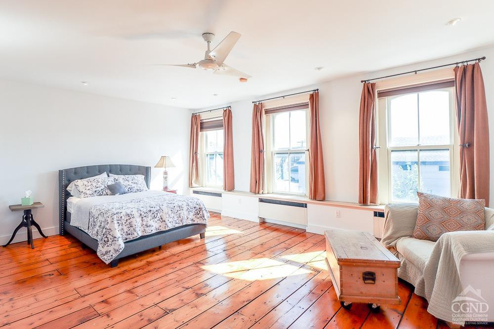 258 Warren Street Hudson, NY 12534 - Photo 18 of 31 a spacious bedroom with a bed and wooden floor