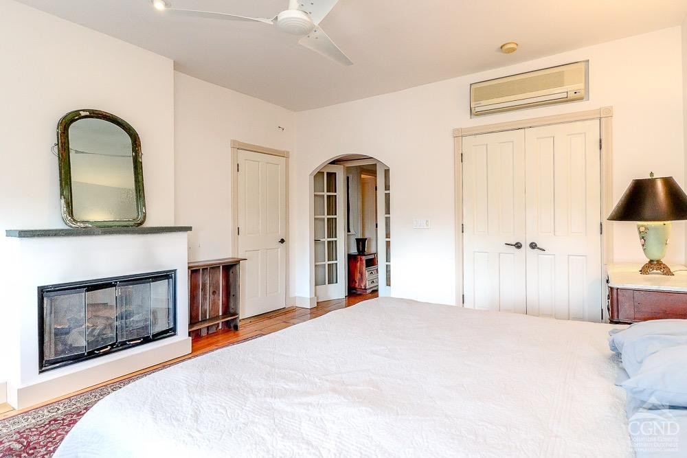 258 Warren Street Hudson, NY 12534 - Photo 21 of 31 a bedroom with a bed and a fireplace