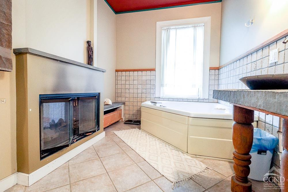 258 Warren Street Hudson, NY 12534 - Photo 25 of 31 a bathroom with a sink a mirror and a bathtub