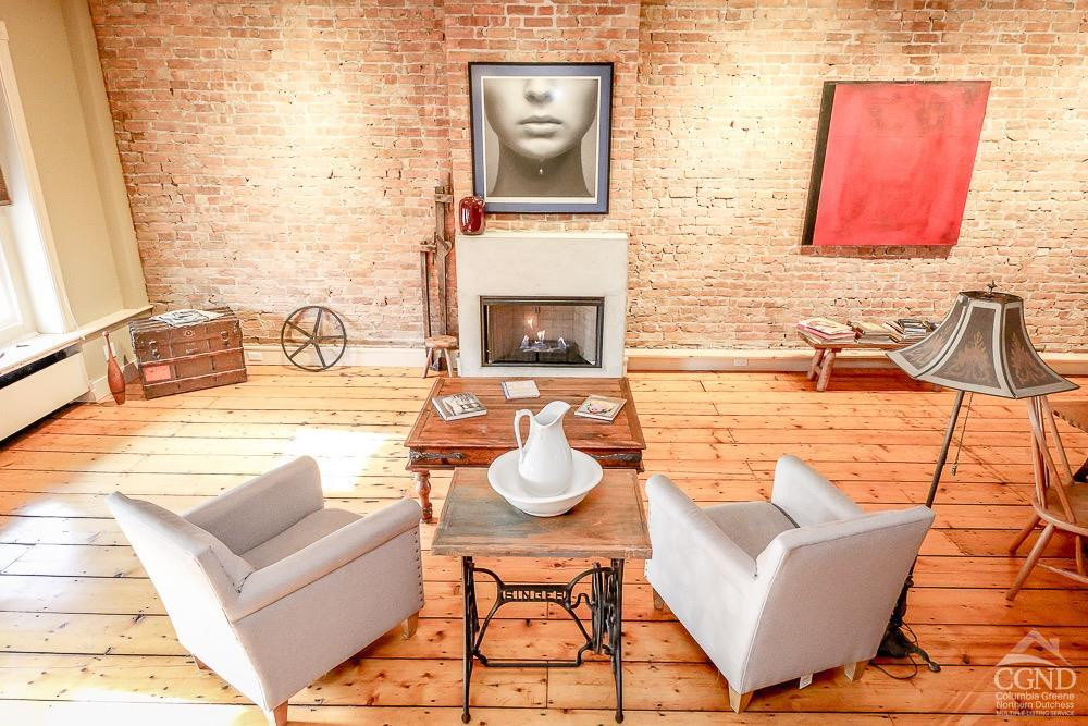 258 Warren Street Hudson, NY 12534 - Photo 3 of 31 a living room with furniture and a fireplace