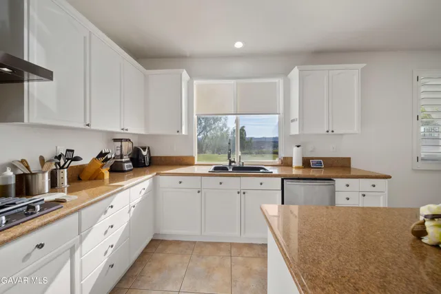 a kitchen with stainless steel appliances granite countertop a sink and cabinets