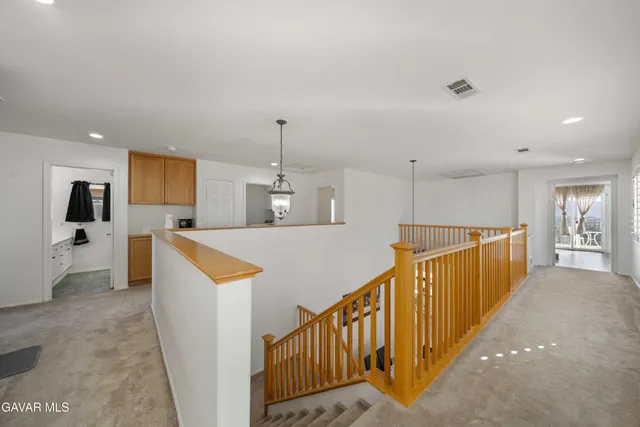 a view of a kitchen with kitchen island wooden floor and electronic appliances