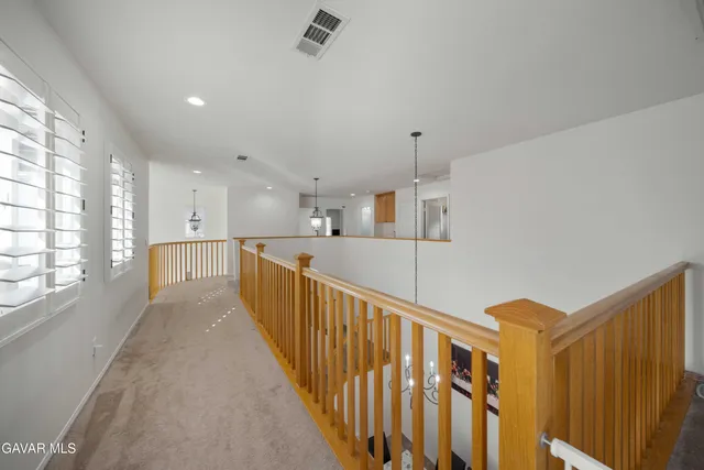 a view of a kitchen with wooden floor and windows