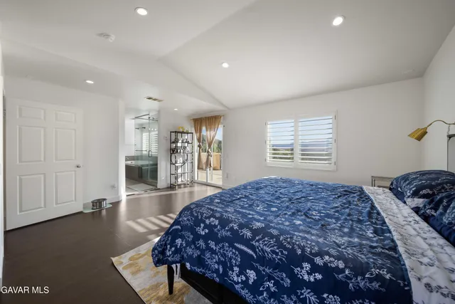 a bedroom with bed and window