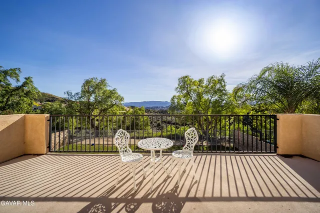 a view of a roof deck with wooden floor and fence