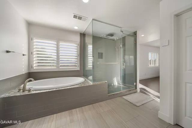 a bathroom with a bathtub and a sink
