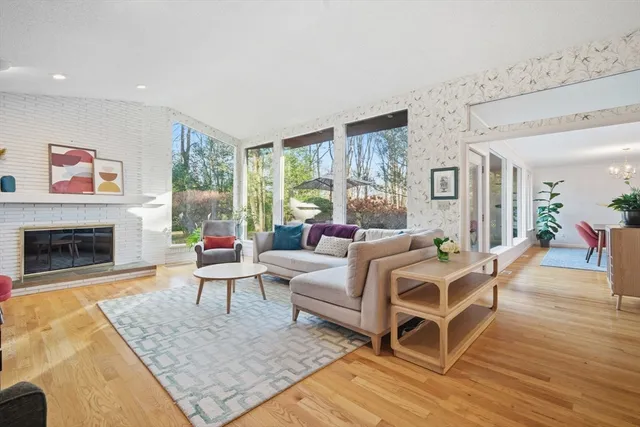 a living room with furniture fireplace and window